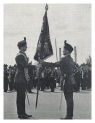 WOI (RSM) D M Mulvaney hands over the Regimental Colour to the Ensign, Lt J C W Brooks.